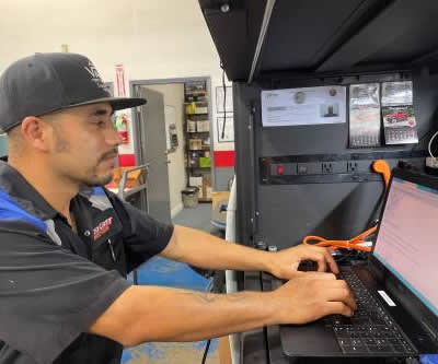 huntington beach auto repair - tech on computer